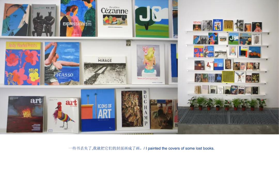 展览现场照片：左侧近景是陈列在白色书架上的艺术类画册；右侧远景是整面墙悬挂展示的书籍，前方摆着一排绿植。