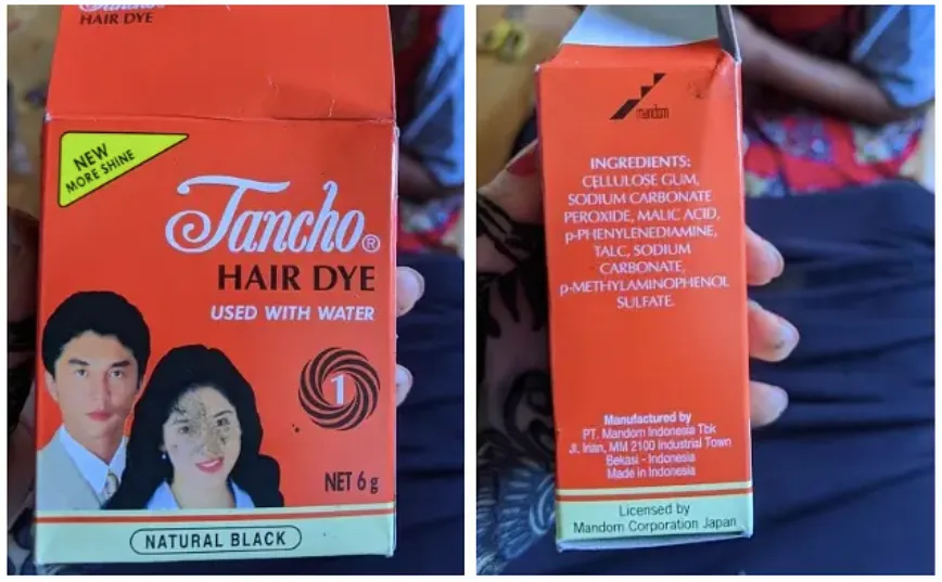 橙色包装盒,左图印有'Tancho HAIR DYE'字样及一男一女东亚人像,标注'NATURAL BLACK';右图为成分表,列出Cellulose Gum、Sodium Carbonate、Peroxide、p-Phenylenediamine等成分,产地印度尼西亚,Mandom公司生产。